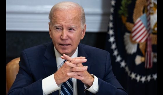 President Joe Biden sits with clasped hands during a meeting about the ongoing fentanyl crisis in the Roosevelt Room of the White House in 2023.