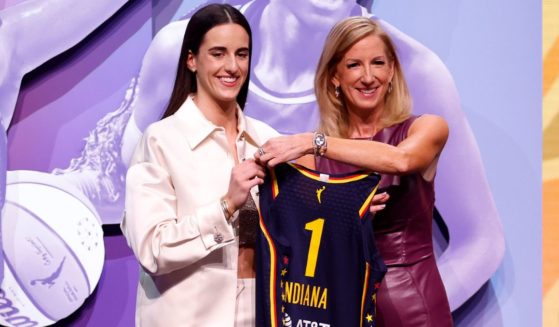 Caitlin Clark posing with WNBA Commissioner Cathy Engelbert after being drafted first by the Indiana Fever at the 2024 WNBA Draft in New York City.