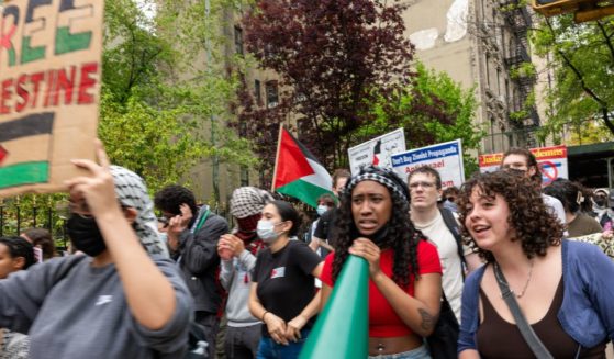 are seen walking from Columbia University to Hunter College as protests at area universities and colleges continued May 6 in New York City.