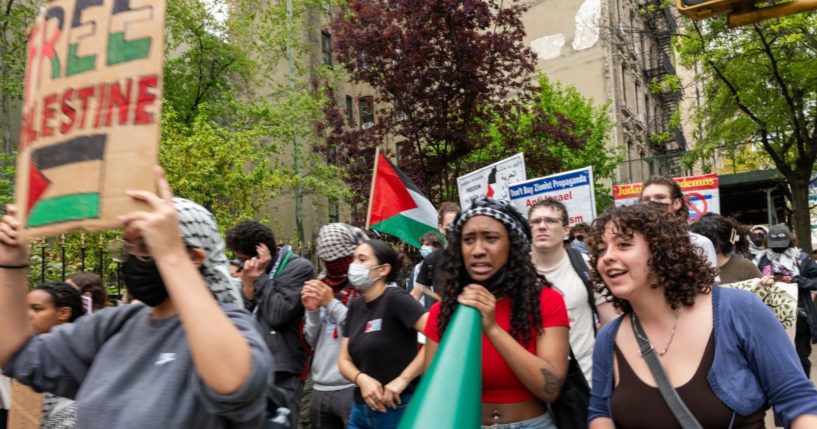 are seen walking from Columbia University to Hunter College as protests at area universities and colleges continued May 6 in New York City.