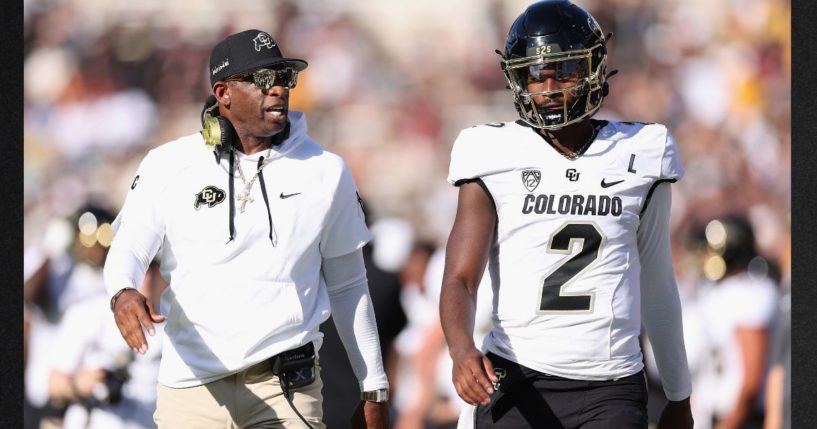 Head coach Deion Sanders of the Colorado Buffaloes talks with his son, quarterback Shedeur Sanders, during the NCAAF game against the Arizona State Sun Devils Oct. 7 in Tempe, Arizona.