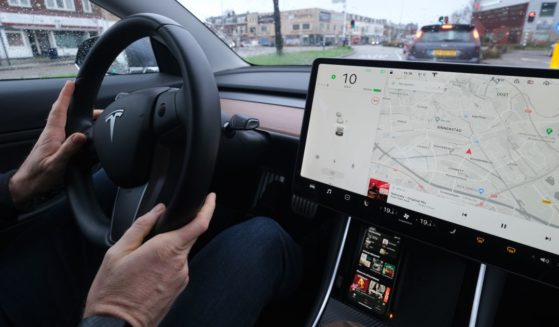 A man drives his Tesla Model 3 in Utrecht, The Netherlands, on Dec. 27, 2020.