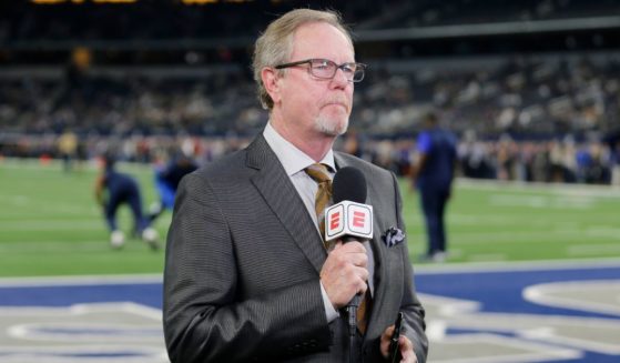 ESPN reporter Ed Werder reports from the field prior to an an NFL football game between the Minnesota Vikings and the Dallas Cowboys in Arlington, Texas, in a file photo from Nov. 10, 2019. Werder announced Thursday he and the sports network are parting ways.