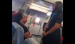 A passenger argues with a flight attendant on a Frontier Airlines flight.
