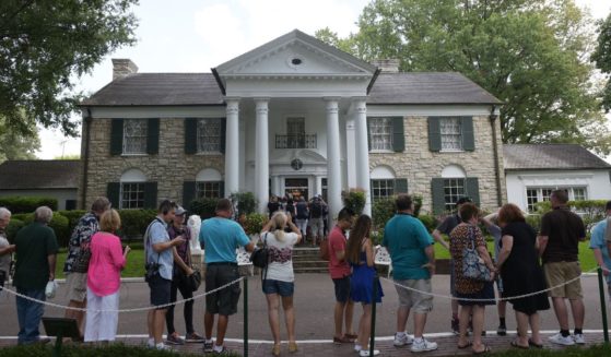 Visitors line up to enter the Graceland mansion of Elvis Presley in Memphis, Tennessee, on Aug. 12, 2017.