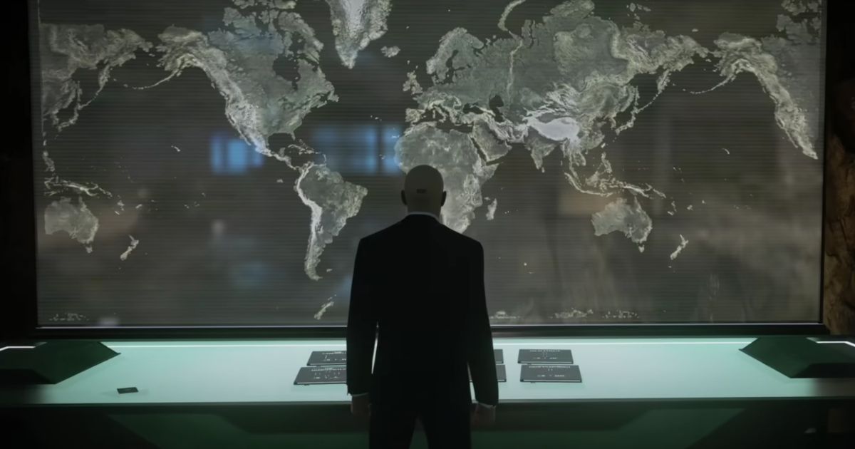 "Hitman" series protagonist Agent 47 looking at a map of the world.