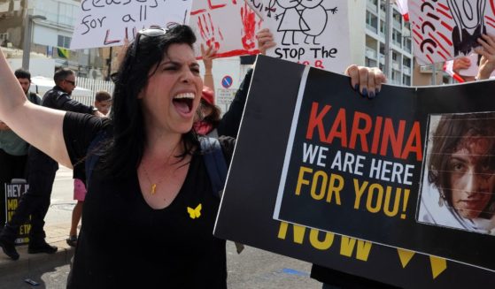 A woman holds a placard bearing the image of 19-year-old Israeli hostage Karina Ariev in front of the Branch Office of the U.S. embassy in Tel Aviv, Israel, in a file photo from March 1.