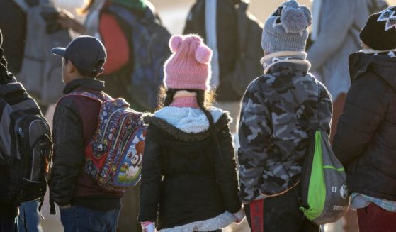 Ecuadorian immigrant children await transport from the U.S.-Mexico border in Lukeville, Arizona, on Dec. 7.