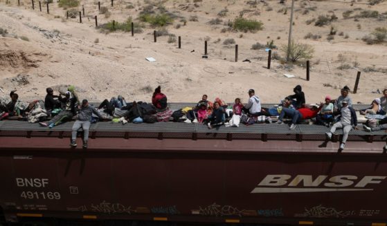 Illegal Immigrants travel on freight cars of the Mexican train known as "The Beast" as they arrive at the border city of Ciudad Juarez, in Chihuahua state, Mexico, on April 24.