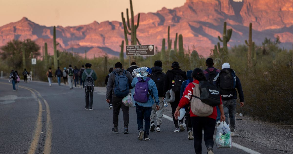Illegal immigrants walk into the United States after crossing from Mexico to Lukeville, Arizona, on Dec. 7.