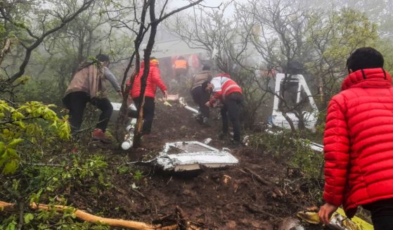 Iranian rescue teams recover the bodies from the crash site of the Iranian presidential helicopter in the dense forest of Dizmar between the cities of Varzaqan and Jolfa in East Azerbaijan province, Iran on Monday.