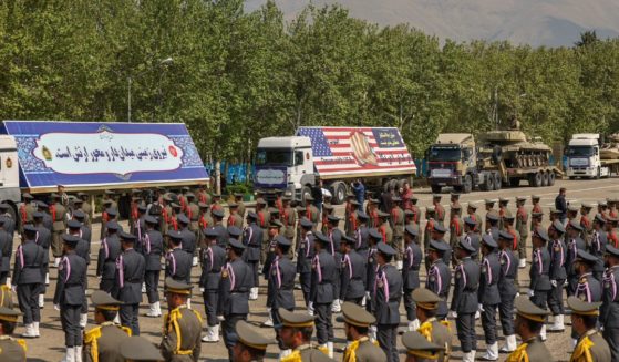 Military equipment and an image of a fist bursting through a U.S. flag are among the displays at Iran's Army Day ceremony in front of high-ranking political and military leaders in Tehran on April 17.