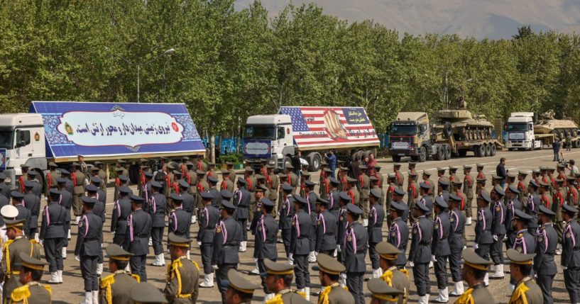 Military equipment and an image of a fist bursting through a U.S. flag are among the displays at Iran's Army Day ceremony in front of high-ranking political and military leaders in Tehran on April 17.