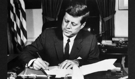 President John F. Kennedy signs the order of a naval blockade of Cuba, on October 23, 1962 in White House, Washington D.C, during the Cuban missile crisis.