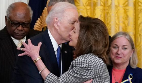Joe Biden kissing Nancy Pelosi during a White House event