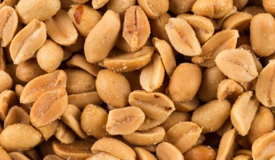 This stock image shows a close up of salted peanuts.