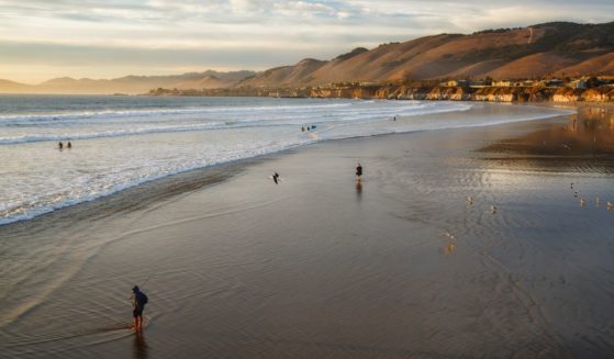 A stock photo shows people enjoying the sunset at Pismo Beach, California, on Jan. 1, 2021.