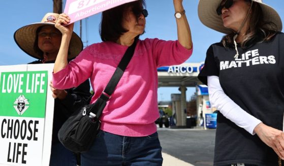Demonstrators protest against abortion pill sales outside a CVS pharmacy March 26 in Torrance, California.