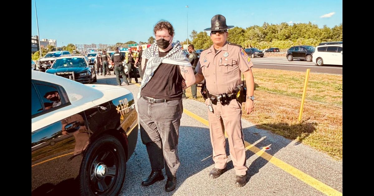 Queers for Palestine protesters who blocked Interstate 4 in Orlando, Florida, are arrested by the Florida Highway Patrol.