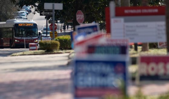 A bus moves near election signs at an election center on the campus of North Carolina State University in Raleigh on Feb. 22.