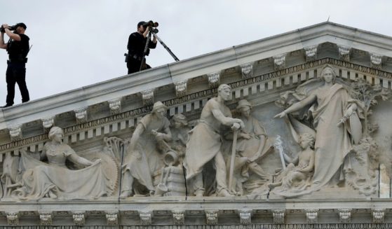 Members of the U.S. Secret Service Counter-Sniper team set up watch from the roof of the House of Representatives in Washington, D.C., as President Joe Biden arrives at the U.S. Capitol in a file photo from March 15, 2023.