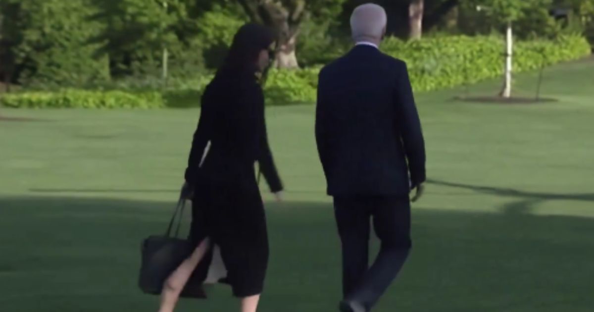While walking to Marine One on Friday, a White House aid quickly moved from one side of President Joe Biden to the other, in an apparent attempt to shield him from the press.