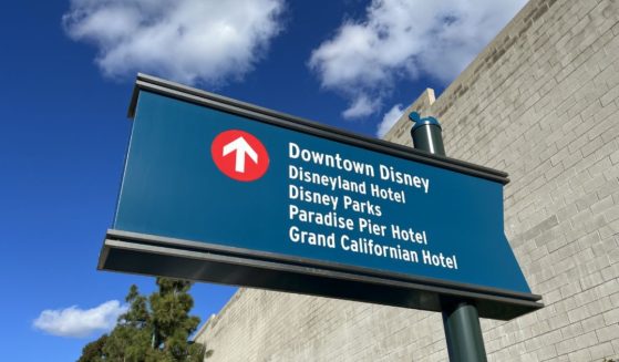 A sign directing traffic towards Downtown Disney and other Disney locations in Anaheim, California.