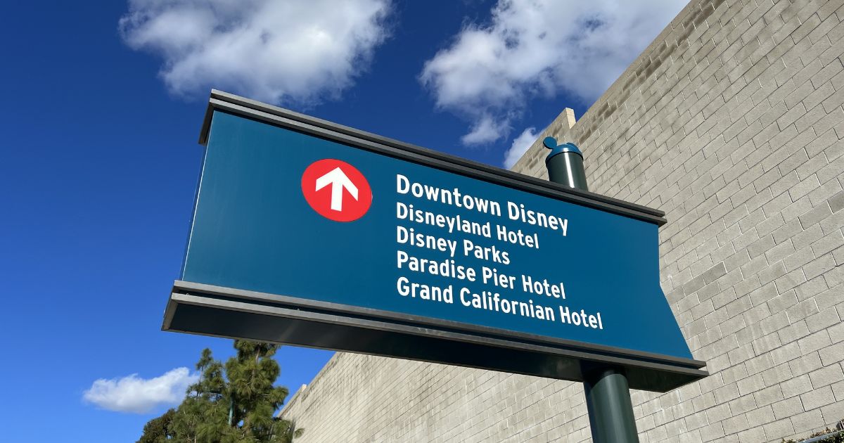 A sign directing traffic towards Downtown Disney and other Disney locations in Anaheim, California.