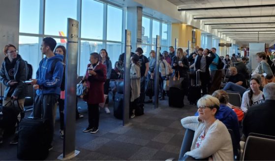 People line up based on boarding group numbers to board a Southwest Airlines flight at Oakland International Airport in California on Jan. 5, 2020.