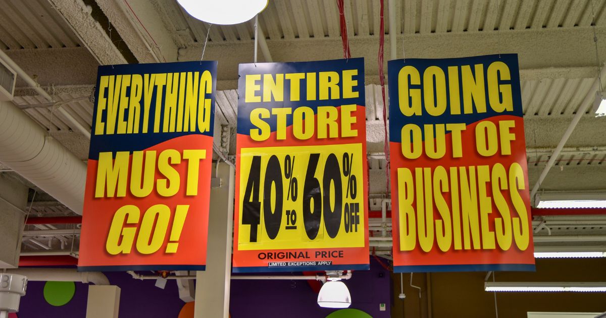 A stock photo shows signs in a store that's going out of business.