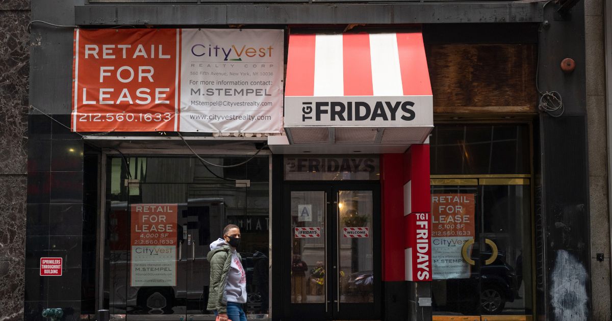 A man walks past a For Lease sign at a closed down TGI Fridays in New York City on Oct. 22, 2020.