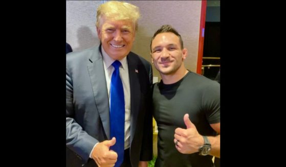 UFC champion Michael Chandler, right, poses with former President Donald Trump.
