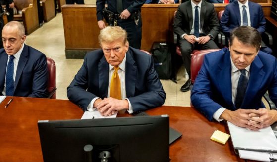 Former President Donald Trump, center, appears in court with attorneys Emil Bove, left, and Todd Blanche, right, for his trial at the Manhattan Criminal Court in New York City on Tuesday.