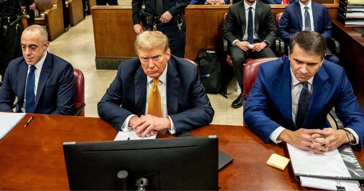 Former President Donald Trump, center, appears in court with attorneys Emil Bove, left, and Todd Blanche, right, for his trial at the Manhattan Criminal Court in New York City on Tuesday.