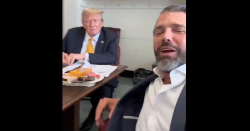 Former President Donald Trump and son Donald Trump Jr. appear in a video from the Manhattan courthouse.