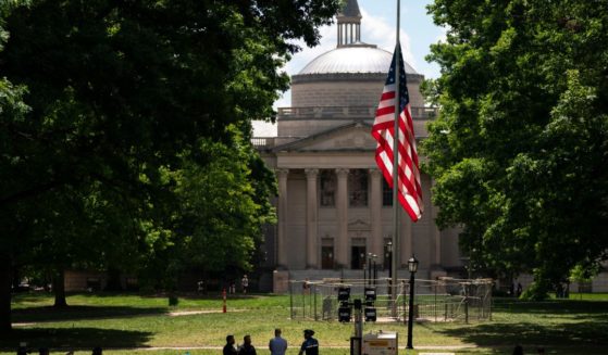 A barricade protects the American flag at Polk Place at the University of North Carolina on Wednesday in Chapel Hill, North Carolina. On Tuesday, protesters removed an American flag and raised a Palestinian flag following a dispersed encampment at Polk Place on the campus of the University of North Carolina.