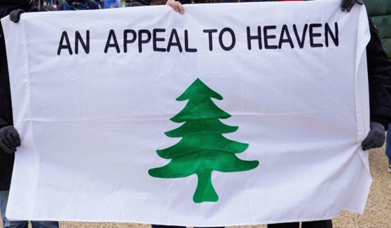 Crowds gather for the "Stop the Steal" rally carrying an "Appeal to Heaven" flag on January 6, 2021 in Washington, DC.