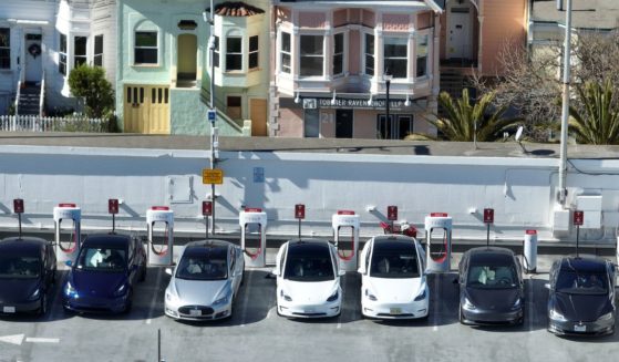 In an aerial view, Tesla cars recharge at a Tesla Supercharger station on February 15, 2023 in San Francisco, California.
