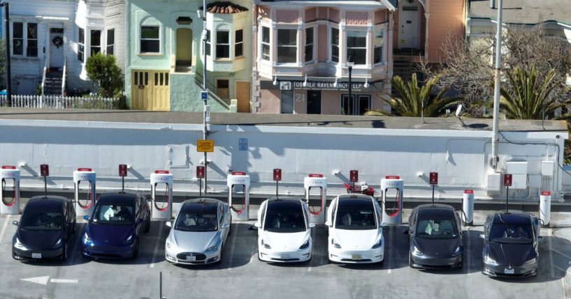 In an aerial view, Tesla cars recharge at a Tesla Supercharger station on February 15, 2023 in San Francisco, California.