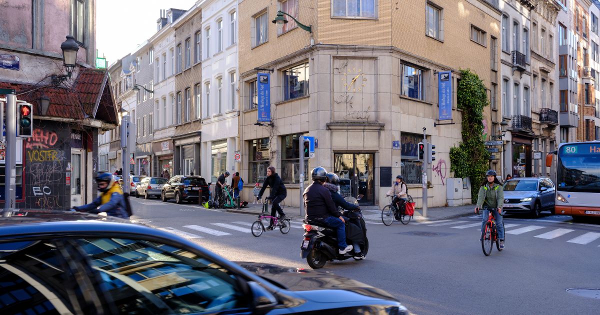 People cross at the intersection between the 'Rue du Trone' and the 'Chaussee de Wavre' on March 28, 2024 in Ixelles, Belgium.