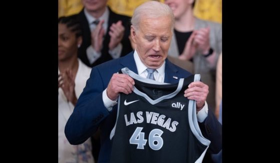Las Vegas Aces forward A'ja Wilson (not pictured) presents a jersey to U.S. President Joe Biden during a ceremony to celebrate the WNBA Champion Las Vegas Aces in the East Room of the White House on May 9, 2024 in Washington, DC.
