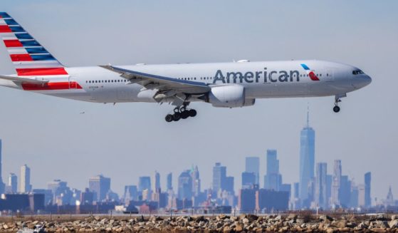 A Boeing 777 passengers aircraft of American Airlines arrives from Milan at JFK International Airport in New York as the Manhattan skyline looms in the background on February 7, 2024.