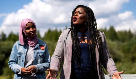 Rep. Ilhan Omar watches as Rep. Cori Bush speaks while visiting the headwaters of the Mississippi River where the Line 3 Pipeline is being constructed on September 4, 2021 in Park Rapids, Minnesota.