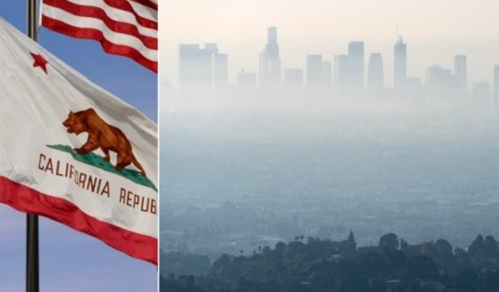 California's state flag, left, against a blue sky is a jarring contrast to a smog and smoke filled Los Angeles skyline.