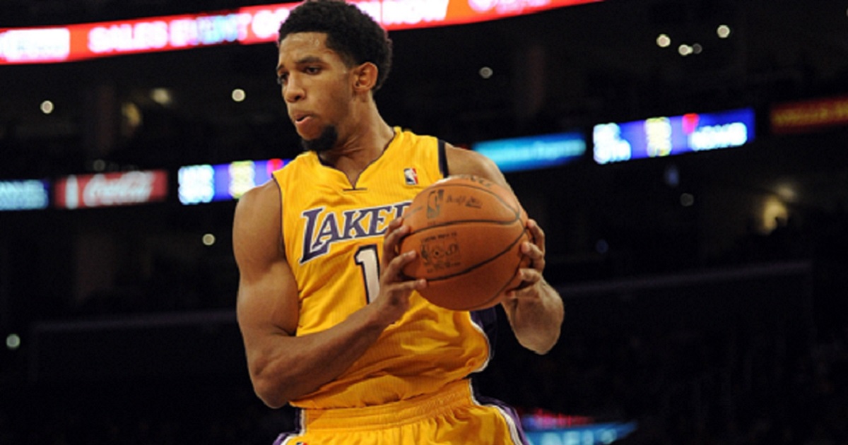 Former NBA player Darious Morris, pictured in a 2011 file photo, holds the ball after snagging a rebound against the Los Angeles Clippers during his time with the Los Angeles Lakers.