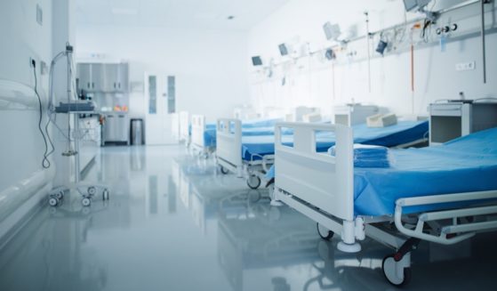 A row of empty hospital beds.
