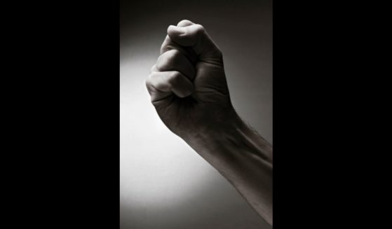This photo shows someone's wrist and hand making a fist as a symbol of the desire to take revenge on an enemy.