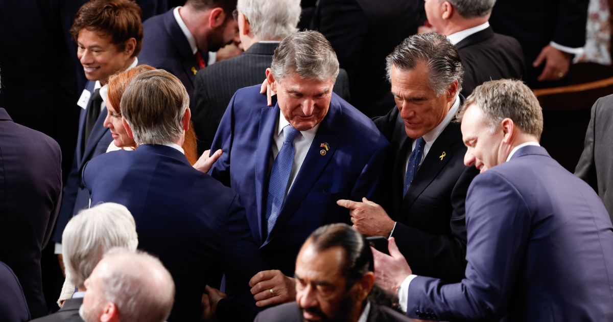 U.S. Sen. Joe Manchin (D-WV) and Sen. Mitt Romney (R-UT) talk prior to the start of President Joe Biden's State of the Union address during a joint meeting of Congress in the House chamber at the U.S. Capitol on March 7, 2024 in Washington, DC.