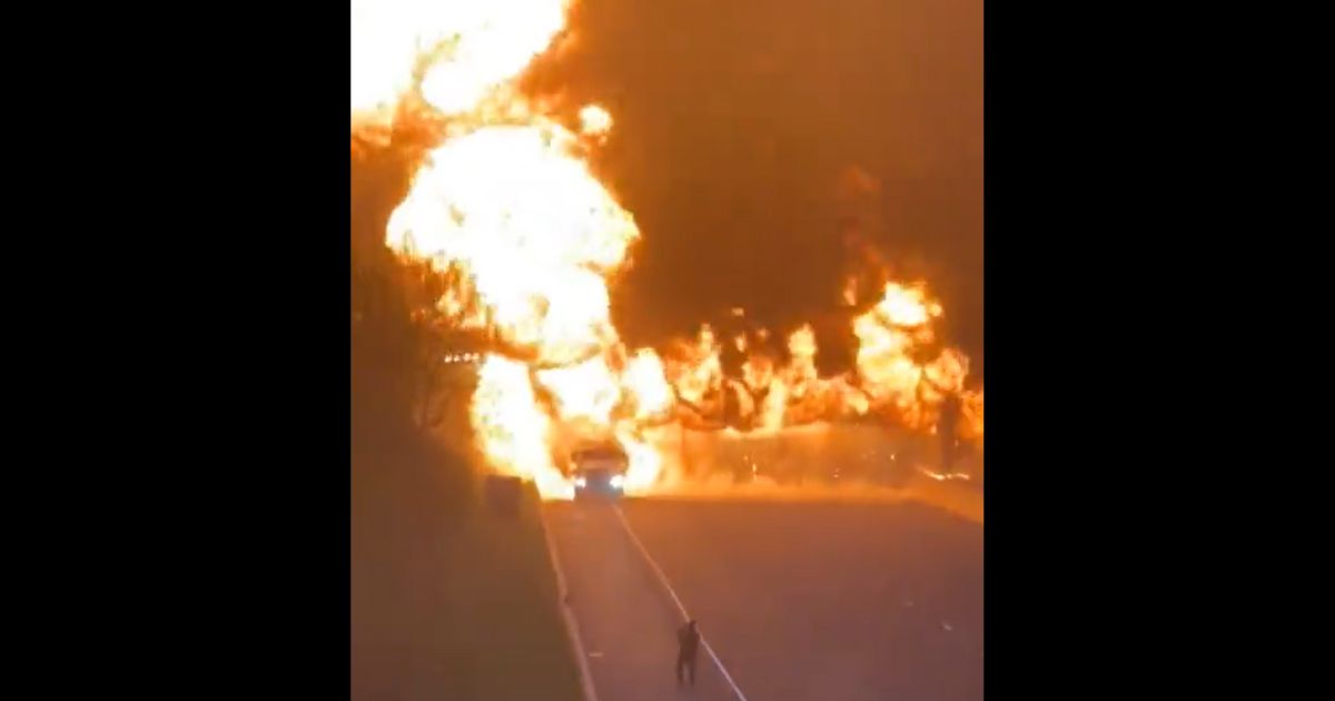 Fiery Scene Unfolds as Gas-Filled Tractor-Trailer Ignites on Highway
