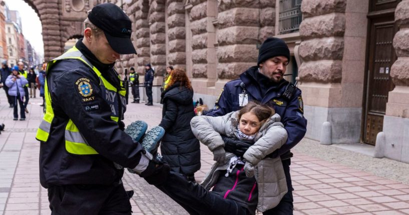 Greta Thunberg is arrested by police officers during a protest with "Reclaim The Future" outside of the Swedish parliament, Riksdag, on March 15, 2024 in Stockholm, Sweden.
